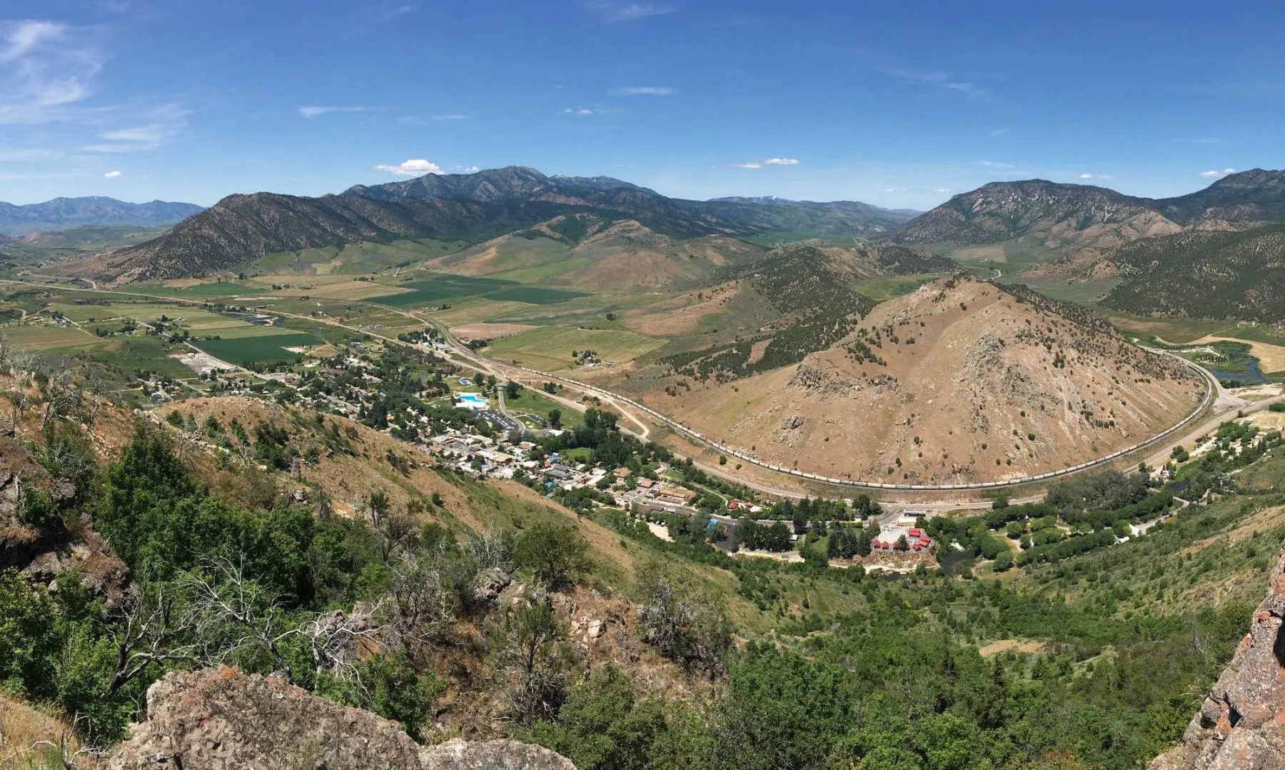 Lava Hot Springs from the cliffs above town — the Portneuf River bends around the hill, the whole valley in view